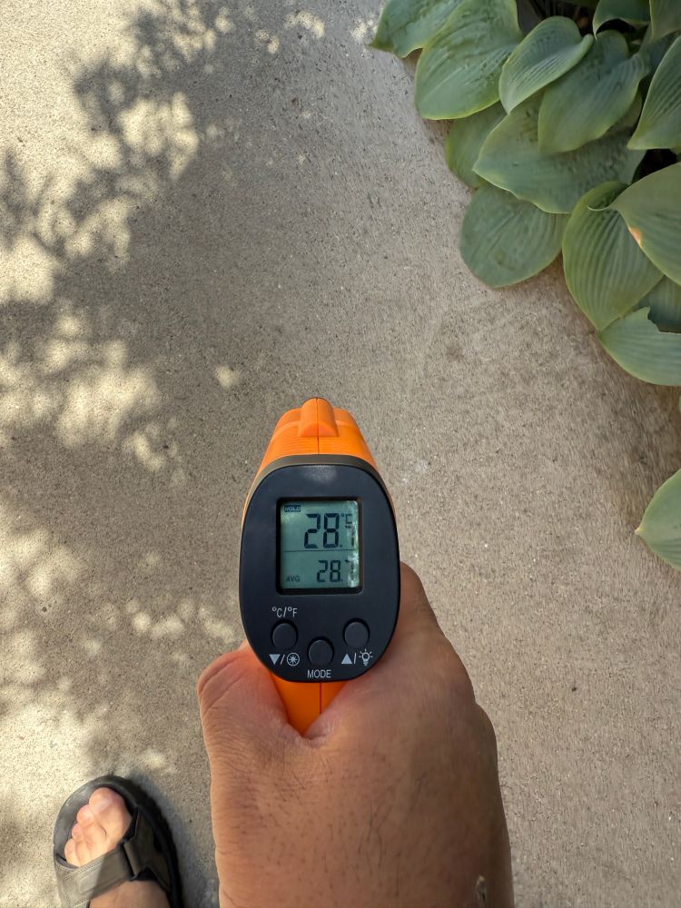 Thermometer reading of concrete in shade on a hot day, reading at 28°C