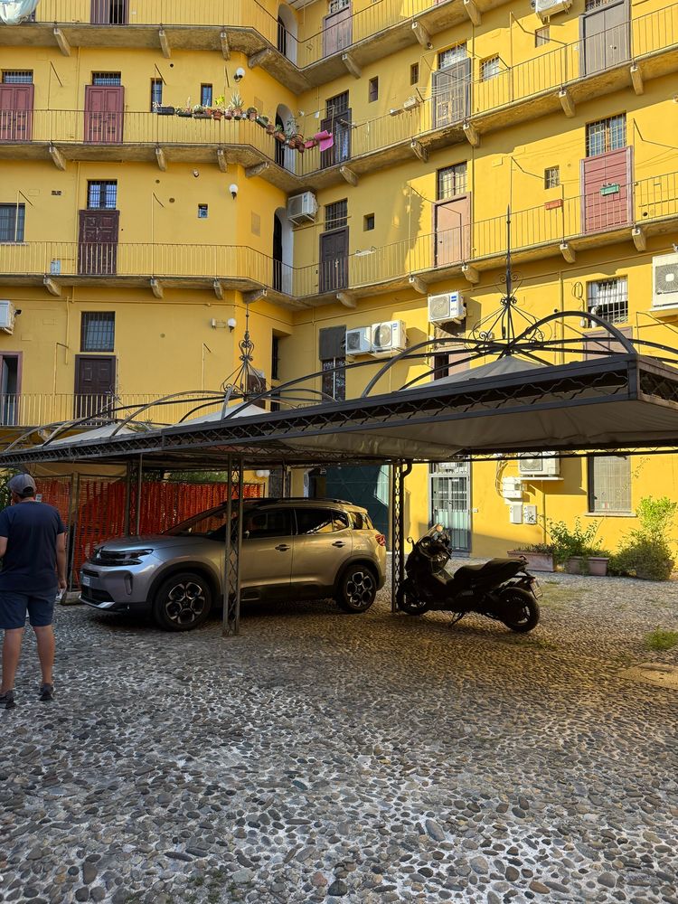 Photo of the same car parked in its spot in a residential lot in Navigli.