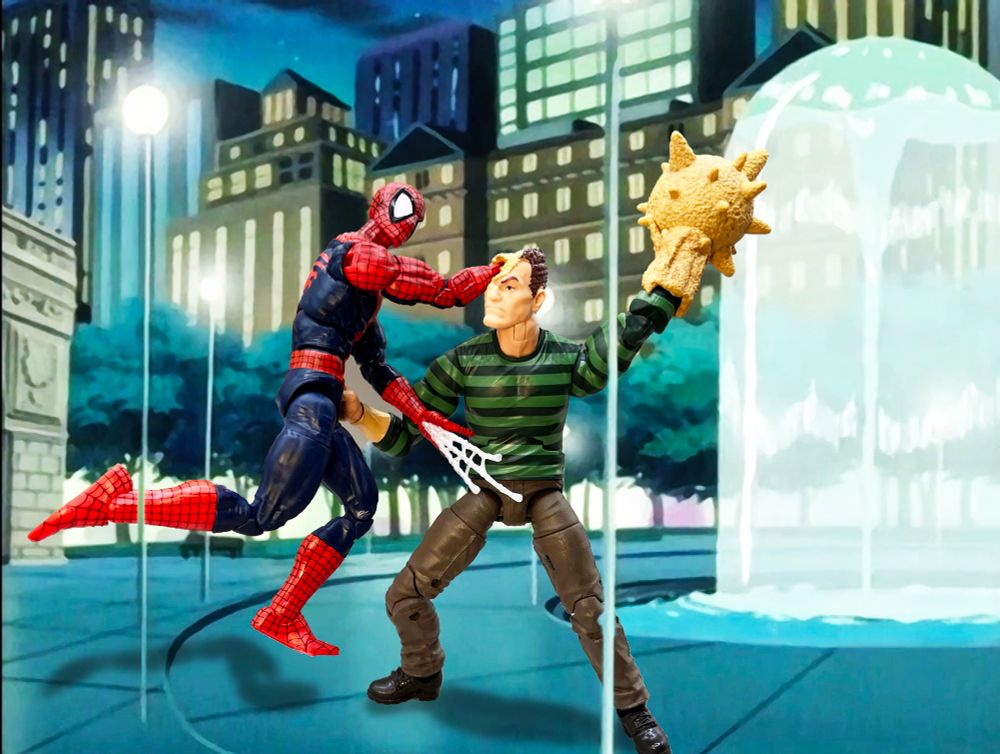 Spider-Man fights classic comic/cartoon Sandman near a water fountain from the 90’s cartoon Spidey’s left fist is trapped in Sandman’s face and he’s getting punched in the gut while Sandman raises his spiky bal sand fist.
