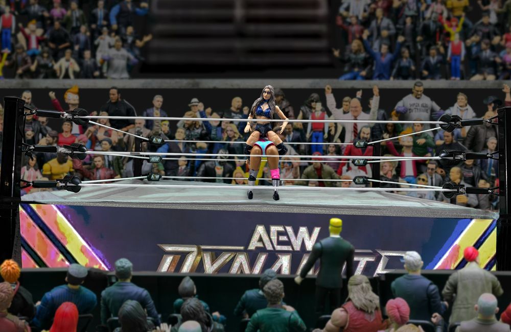 On AEW Dynamite, Skye Blue sits astride a bent-over Willow Nightingale, about to deliver the Code Blue.