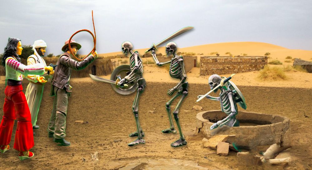 A line of three skeletons advance from a desert well on Indiana Jones, Marion, and Sallah. One of the skeletons is crawling out of the well, two more are advancing with swords and shields. 