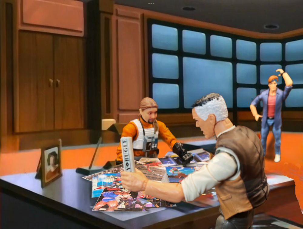 J. Jonah Jameson stands behind his desk at the Daily Bugle Office looking at a bunch of different pictures of Spider-Men that Selfie Series X-Wing Pilot Me is offering him. In the distance, Peter Parker (Animated) is befuddled.