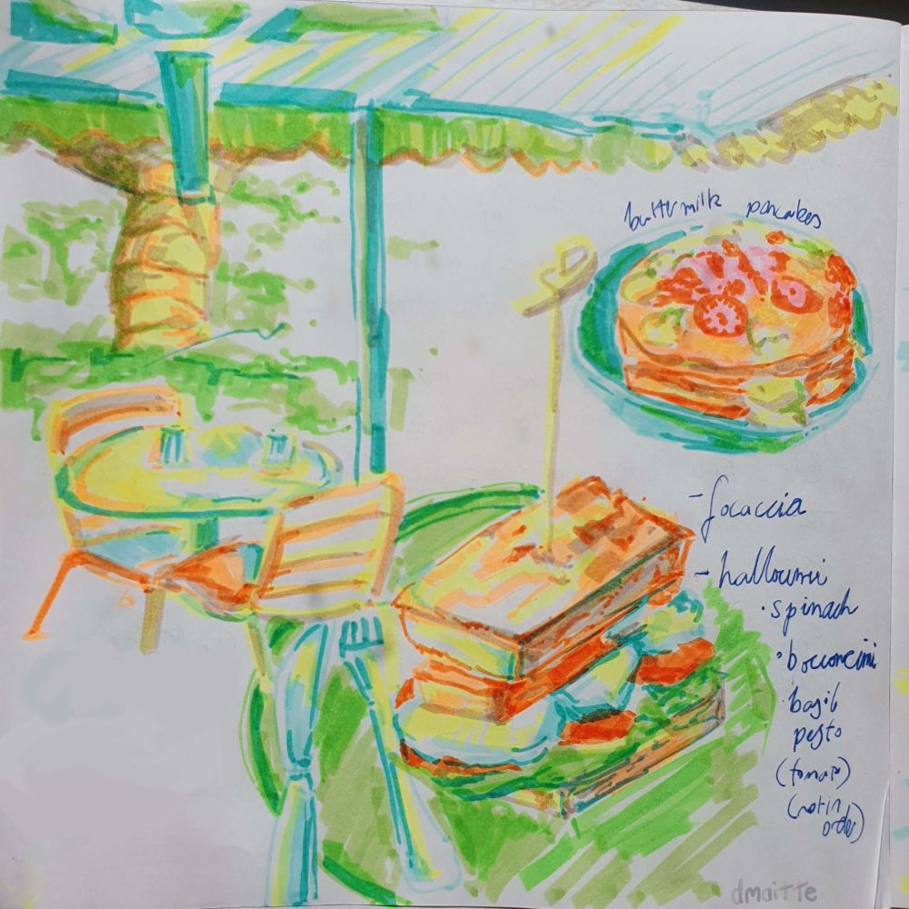 A traditional sketch of a sandwich and pancakes, featuring bright neon colours.