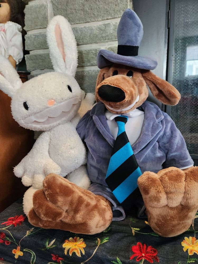 Max, plush white lagagmorph, and Sam, a large plush brown dog in a rumpled suit