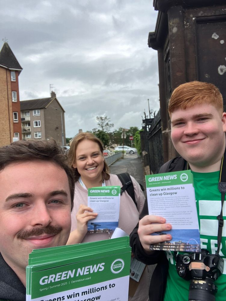 Selfie with Anthony Kate and Allan smiling to camera holding leaflets, with Armadale St at Alexandra Parade in background 