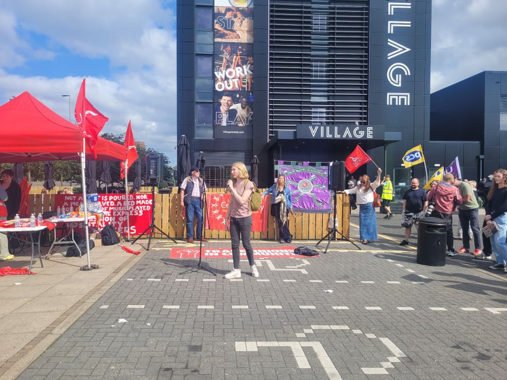 Green MSP candidate Ellie Gomersall speaking in support of the picket outside the Village Hotel