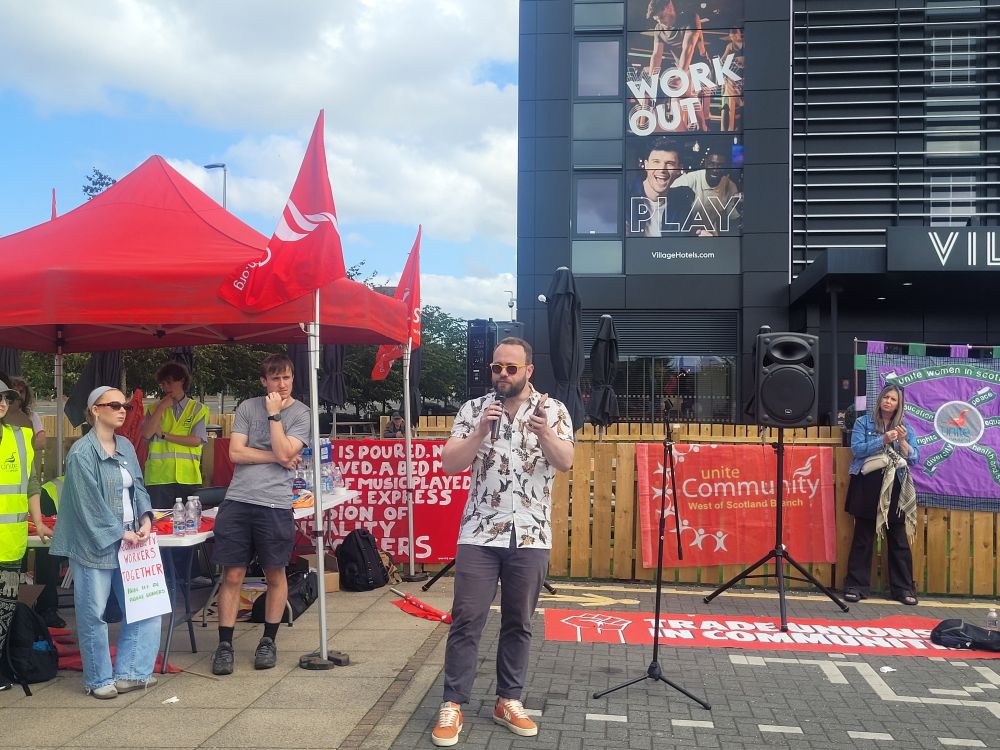 Local Cllr Dan Hutchison speaks to those at the picket.