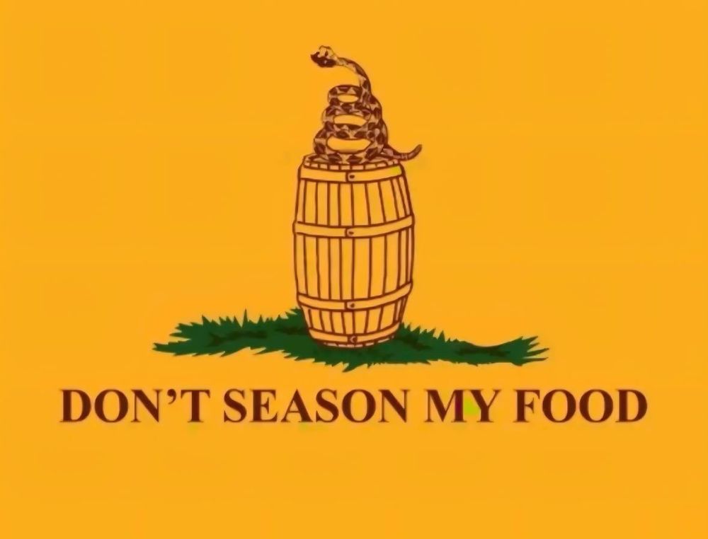 A Gadsden flag with the rattlesnake on top of a Cracker Barrel. The slogan reads, “DON’T SEASON MY FOOD. “
