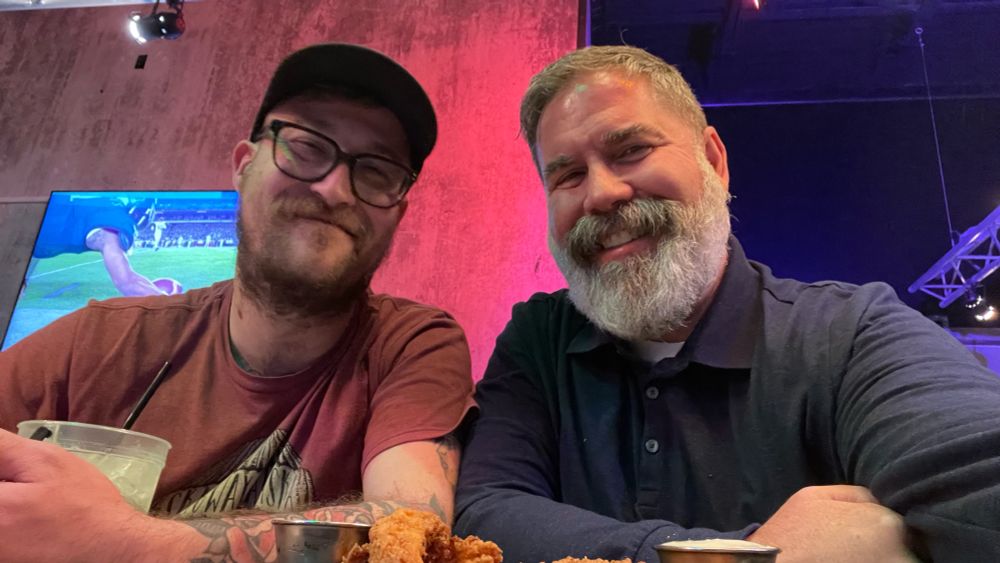 Boy and his dad sitting at a bar having drinks 