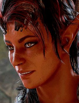 a close up of a woman 's face with horns on it