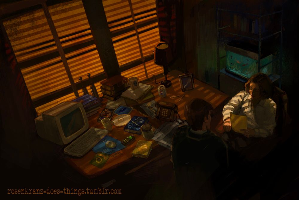 Mulder's apartment with soft orange light streaming through the blinds. his desk is cluttered with various books, landline phone, mobile phone, sunflower seeds, mugs, a can of pepsi, and pencils. there's also a lamp and a bulky computer. Scully is sitting in a chair with a file in her hand. Mulder is standing next to her. there's a fish tank in the corner of the room