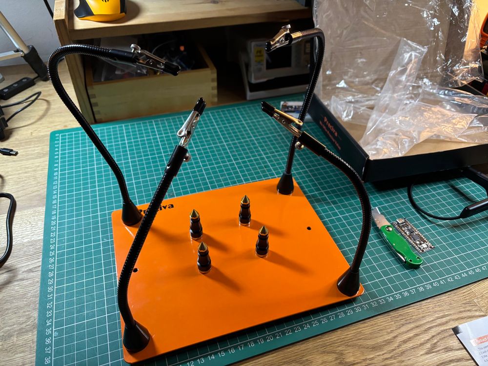 Turbo helping hands soldering aid. Basically a metal slab with rubber feet and magnetically attached googly arms with crocodile clips at the ends. It holds stuff so you don’t have to!