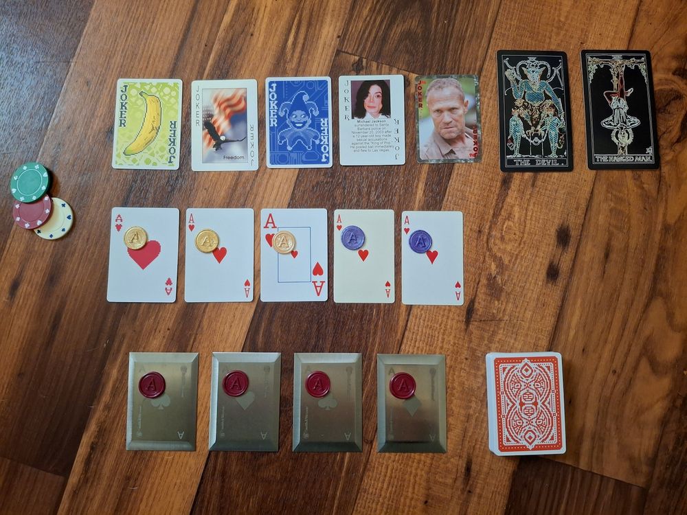 A picture of a Balatro board but it's made with all real cards, including negative Tarots, modded jokers and steel red seal aces.