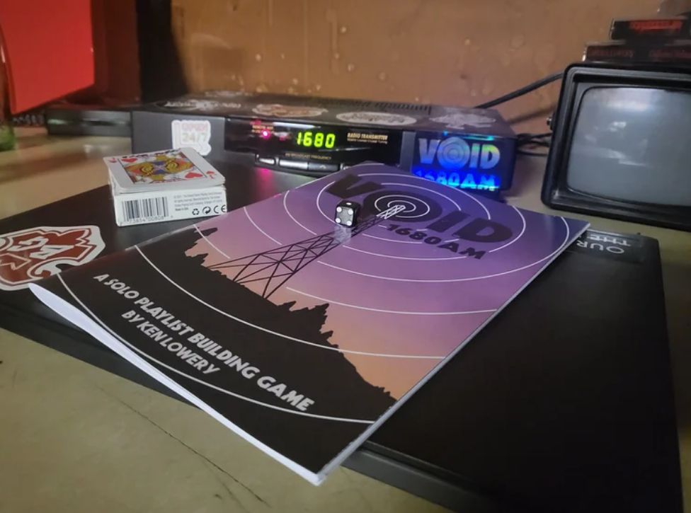 Physical copy of VOID 1680 AM on the broadcast table.