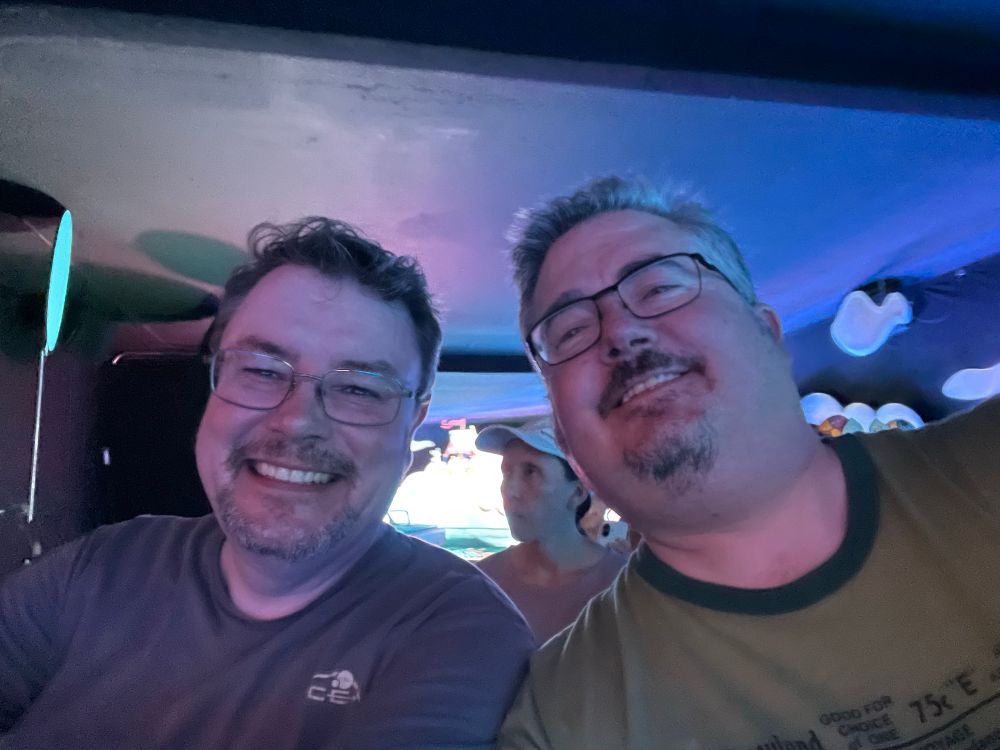 Two gentleman knowingly subjecting themselves to the ear worm of all ear worms by riding Its a Small World.  