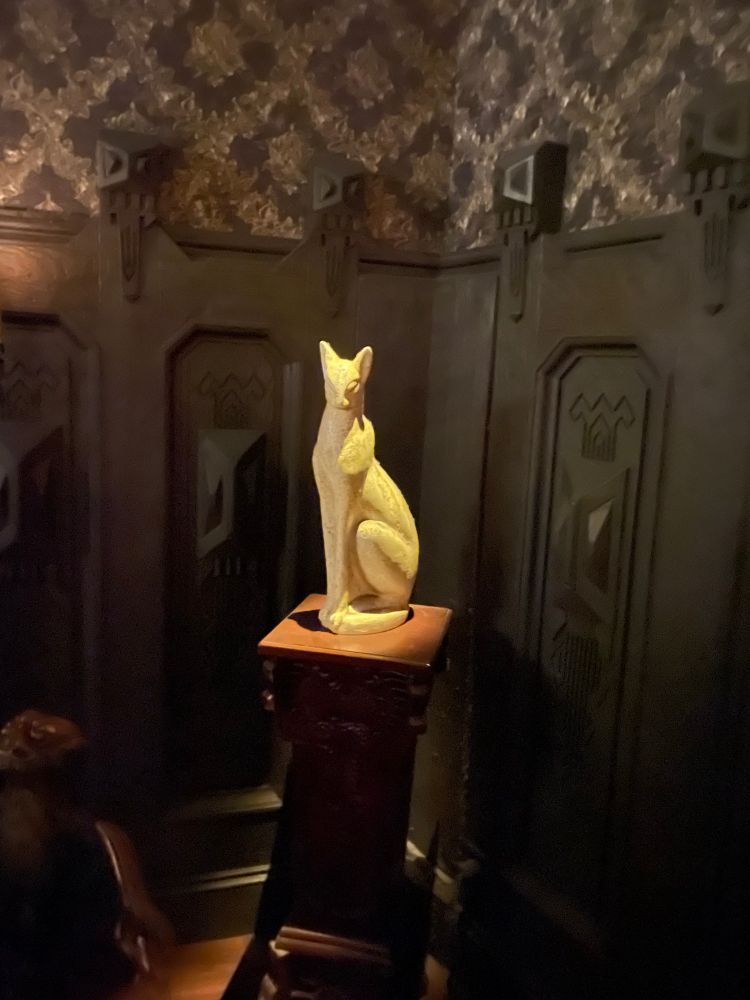 Statue of an alabaster cat within the manor home.   