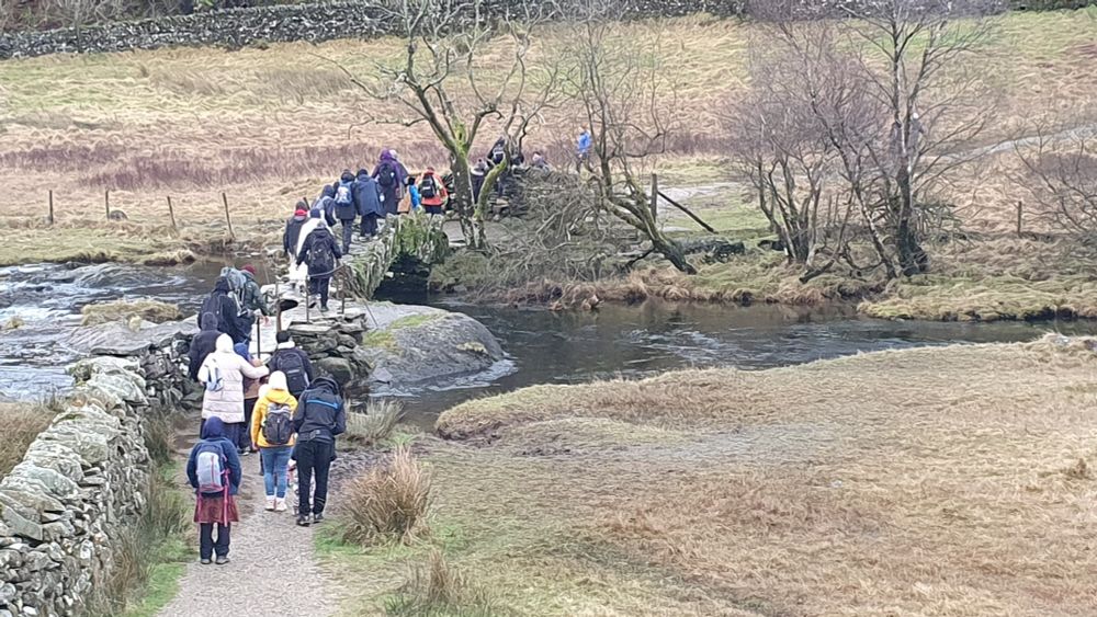 A group crossing Slaters Bridge en route to Cathedral Cave. 