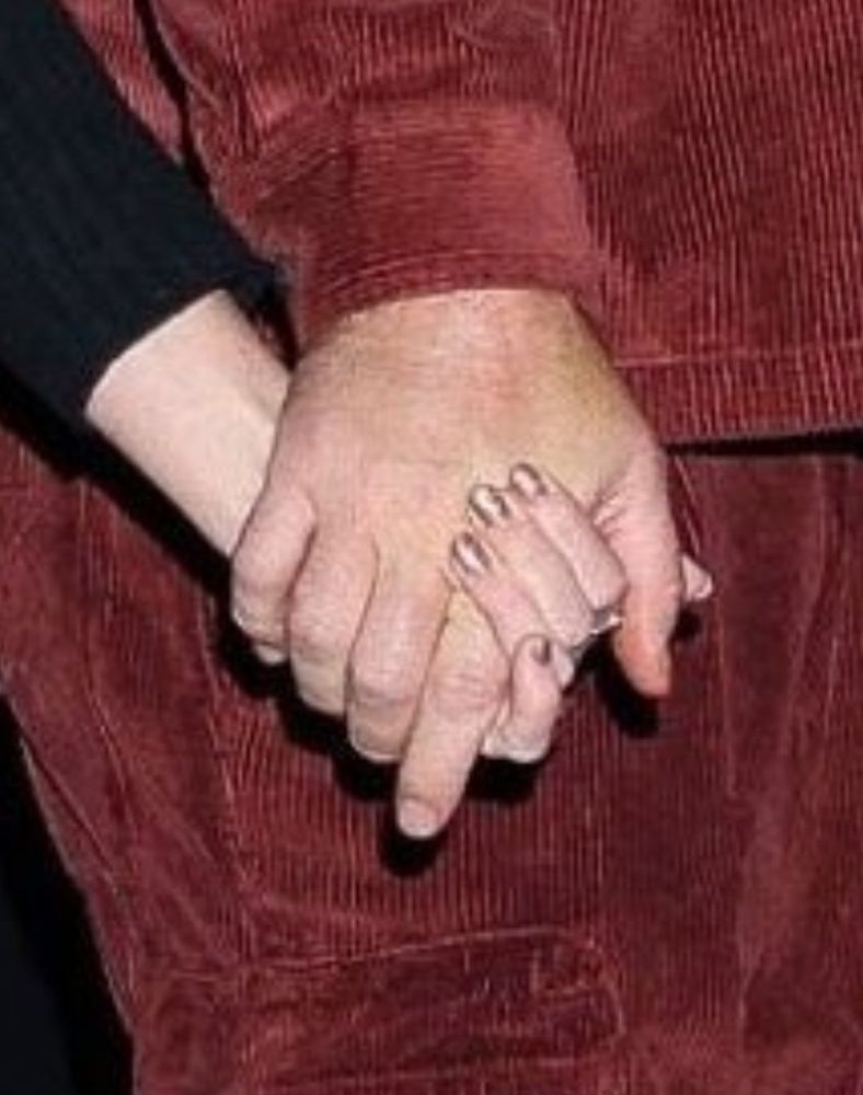 A close up look into the hand holding between Travis and Taylor 