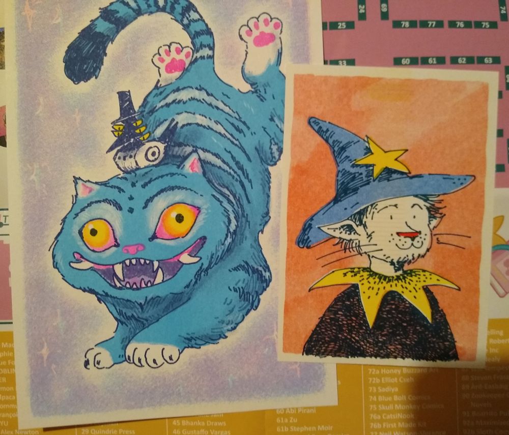 A5 and A6 riso prints. One shows the cat and crow from K-Pop Demon Hunters, the other shows a scruffy looking cat man, with a wizards hat, decorated with a star.
