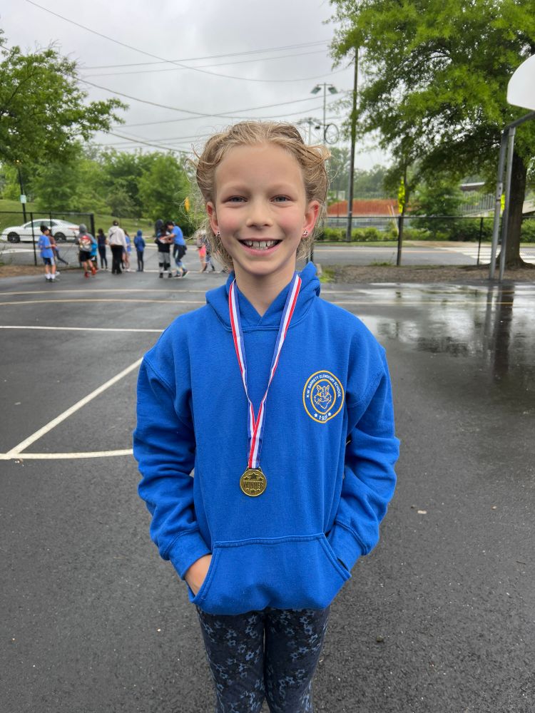 Student smiling with a medal