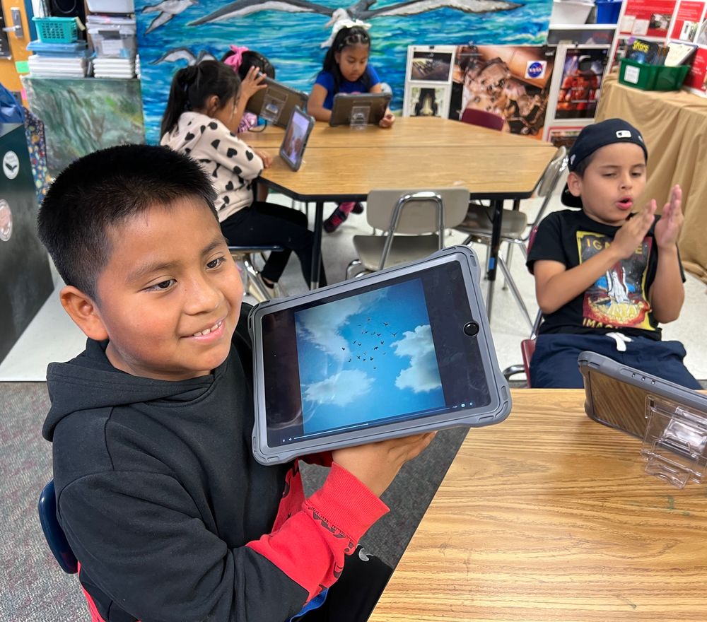 Students listen to music created by a teacher in Panama to go along with migratory bird video