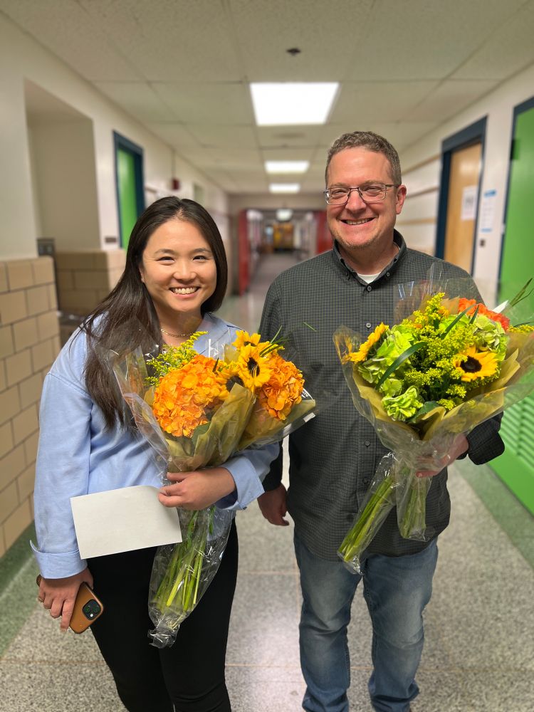 Principal Catherine Han and AP Amin Littman holding flowers 
