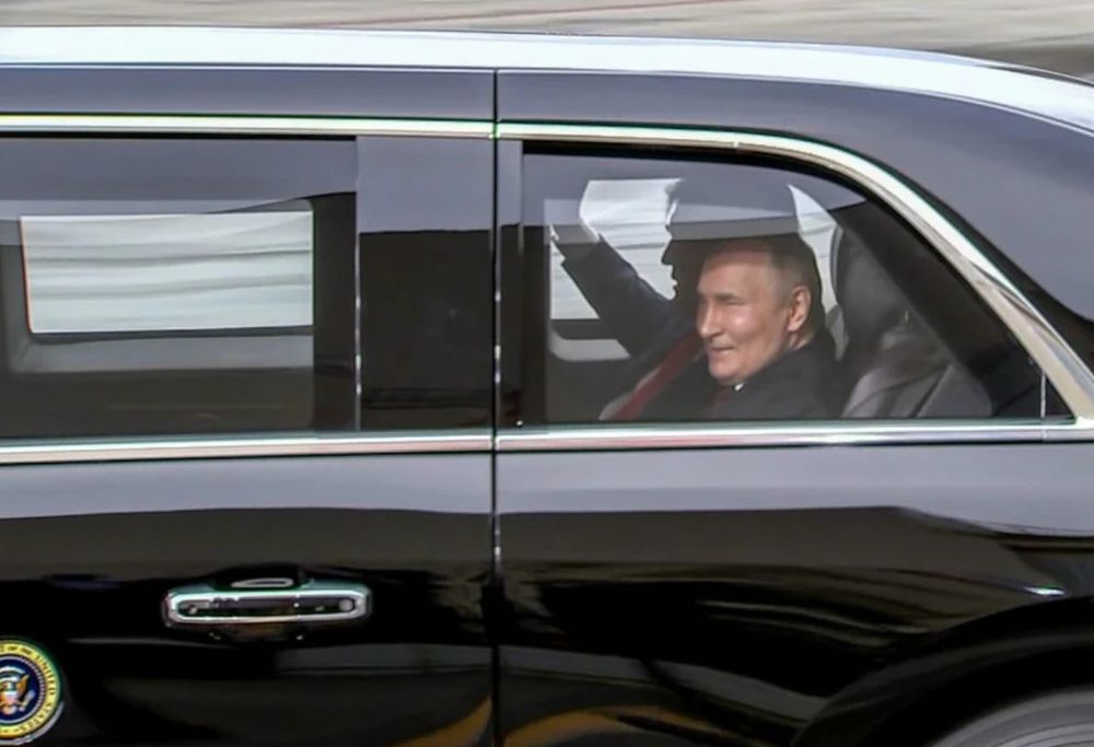 Putin smugly smiling in car w 47 in Alaska 