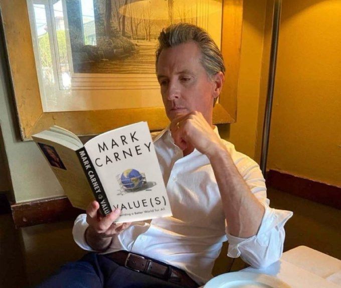 Gavin Newsom photographed reading Mark Carney's book "Value(s)"