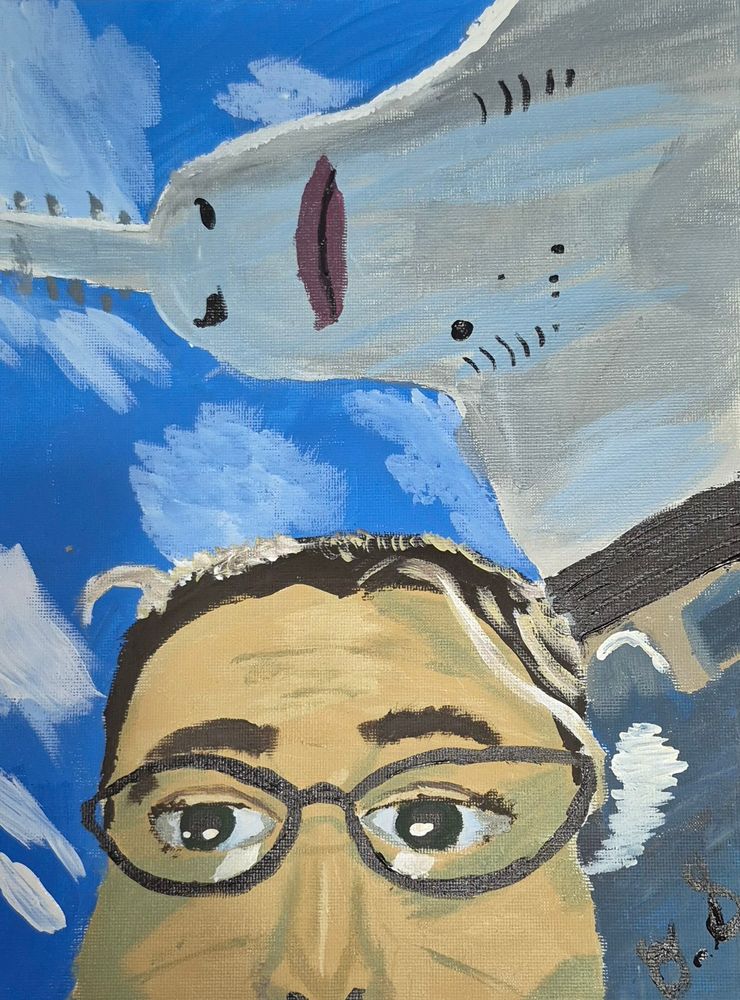 An acrylic painting half my face with a weird looking shark swimming above me. 