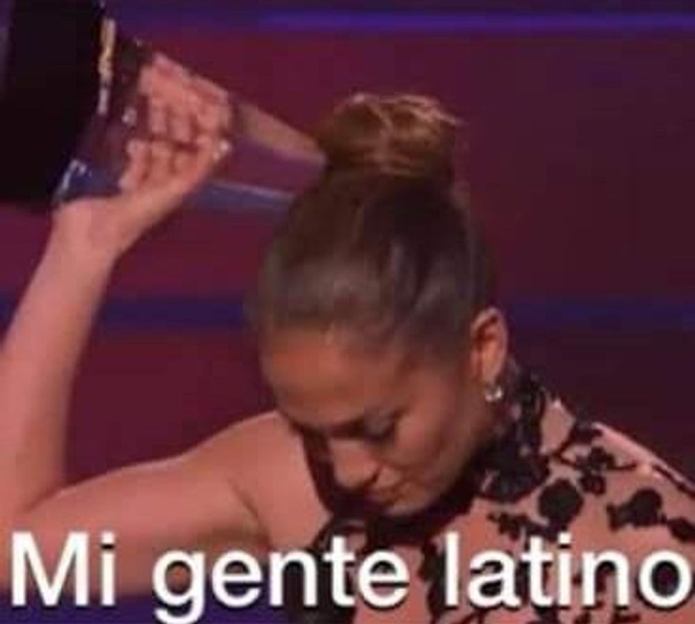 JLo holding up an award with the text "Mi gente latino"