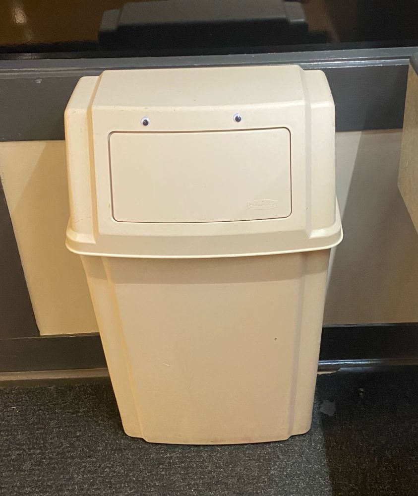 A beige trash can. It has two googly eyes stuck above the flap, so that it looks like a mouth. I don’t know if it’s hungry.