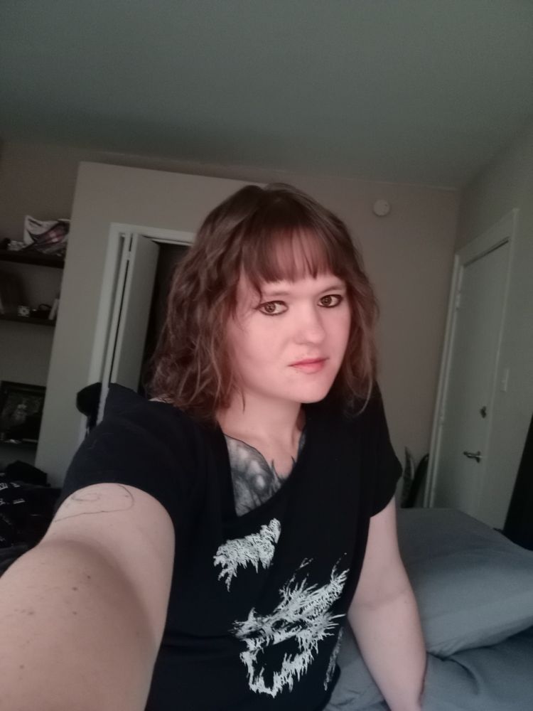 A woman taking a selfie to show off her new hair cut 
