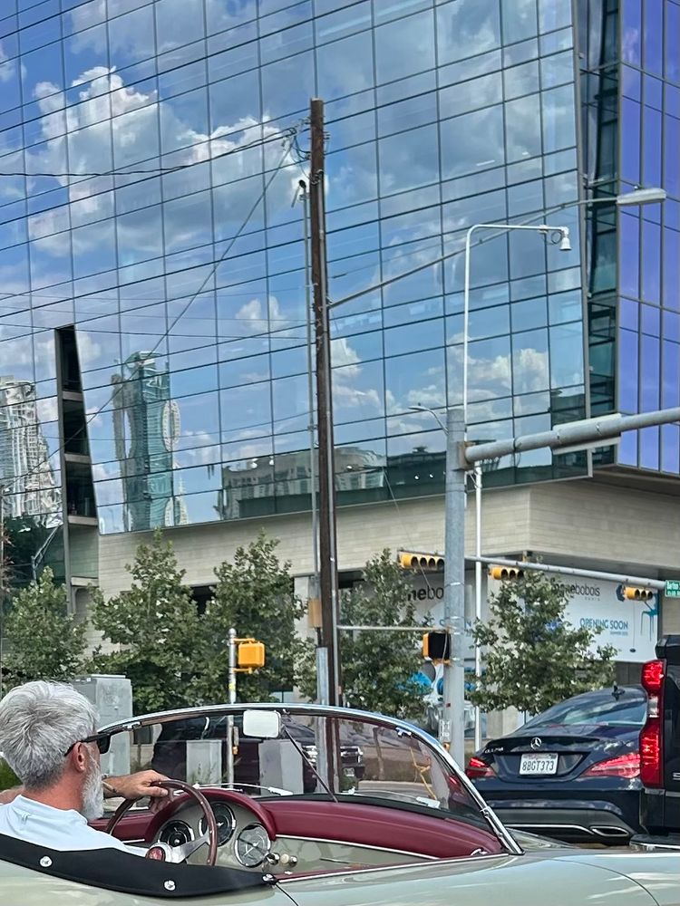 Man driving a fancy old car smoking a fat blunt 