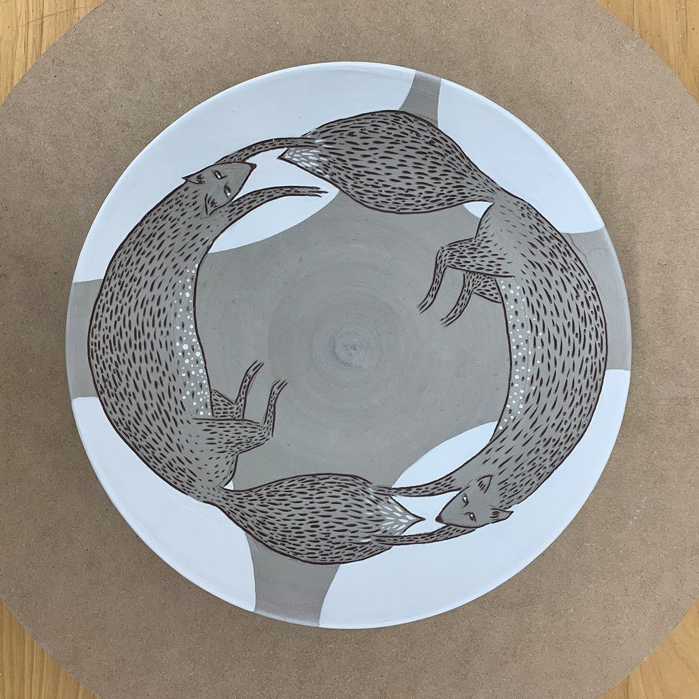 Running foxes plate : engobe and underglaze on dark clay, sgraffito