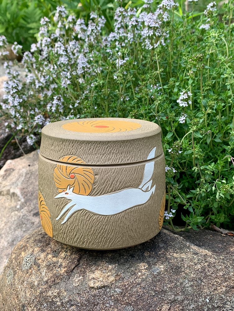 Handmade jar with a running fox and yellow flowers