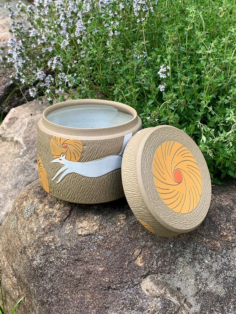 Handmade jar with a running fox and yellow flowers