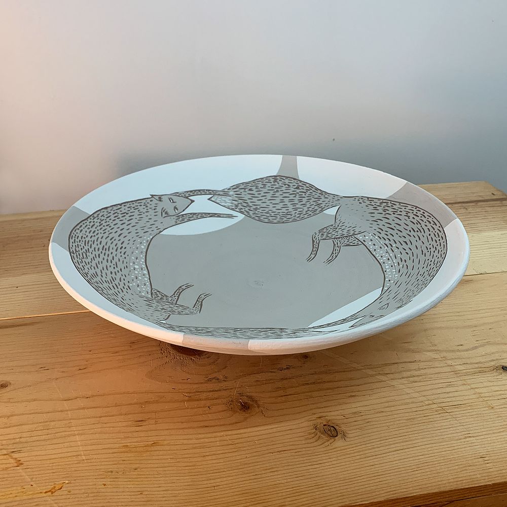 Running foxes plate : engobe and underglaze on dark clay, sgraffito