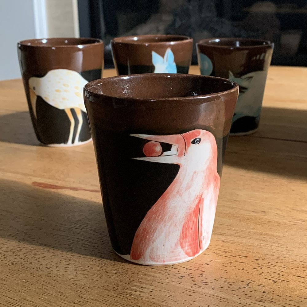 Red raven painted with underglaze on white clay.