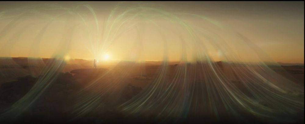 A woman stands on a desert cliff, the rising sun stands golden behind her as massive weaves of the One Power spread out from her in great arching loops up into the sky and down again into the sand. 