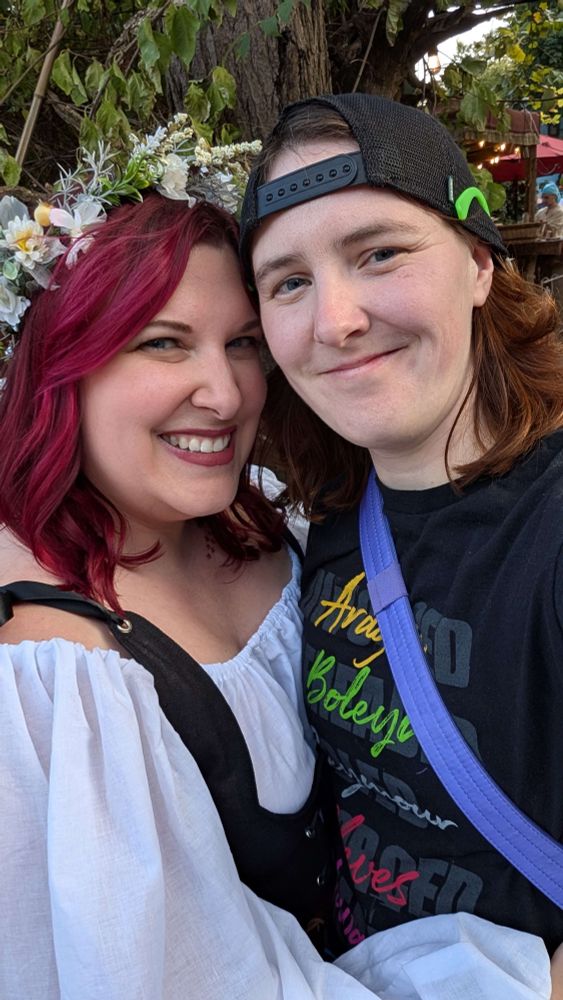 A photo of Meghan and Becca standing forehead to forehead