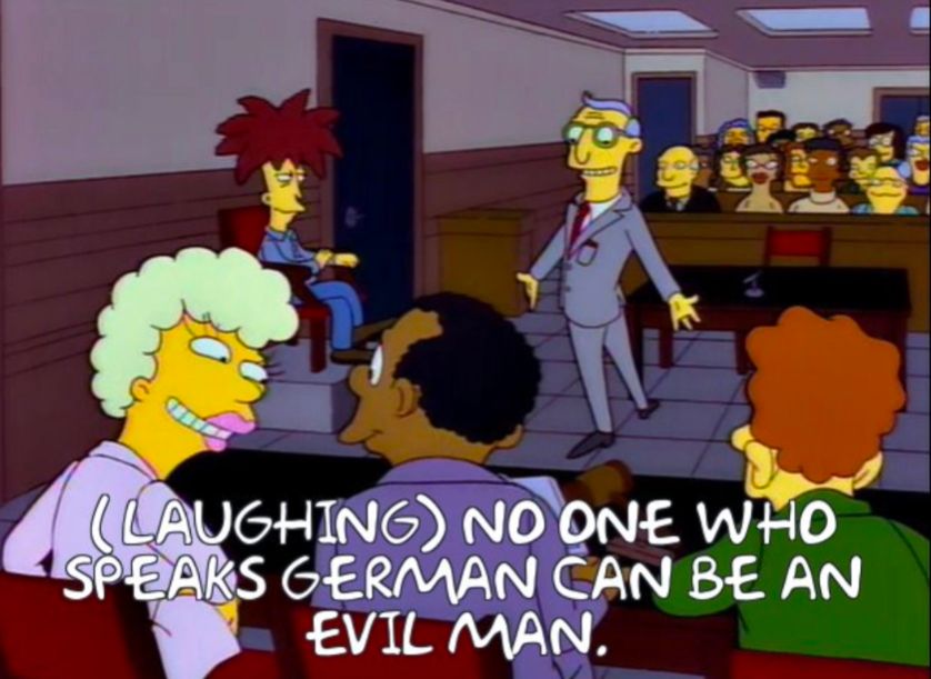Still from Cape Feare episode of The Simpsons showing Sideshow Bob's parole hearing. A woman on the board turns to another board member and says "(laughing)  No one who speaks German can be an evil man"