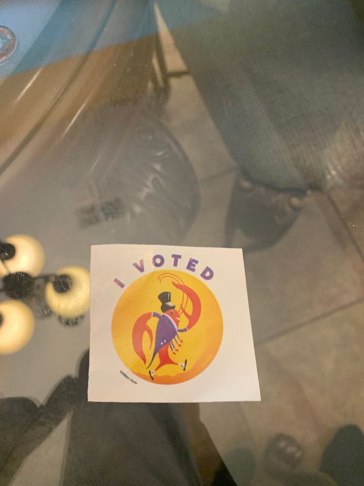 An “I voted” sticker with a crawfish with a top hat