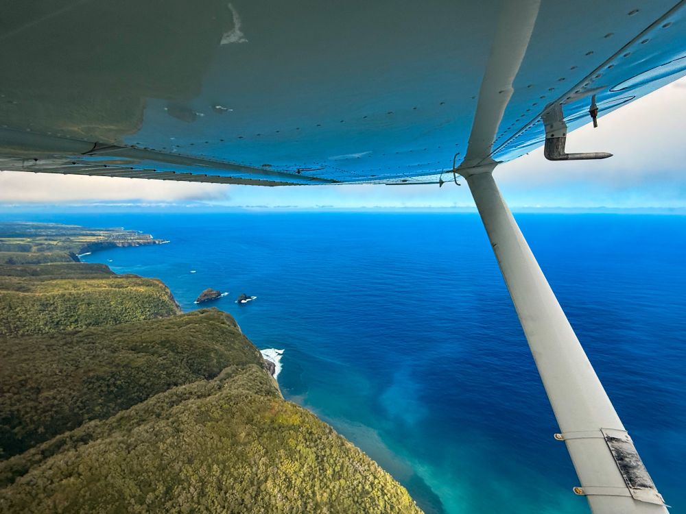 Airplane wing flying over the Big Island of Hawaii