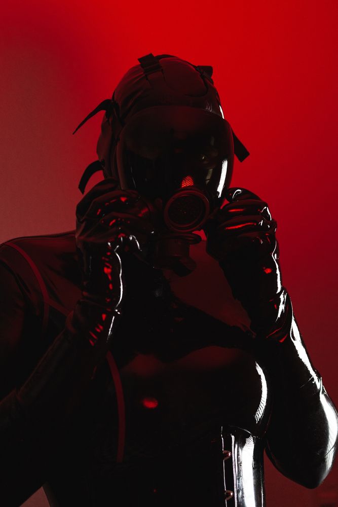 June in heavy rubber latex catsuit, gasmask, corset and shiny gloves...