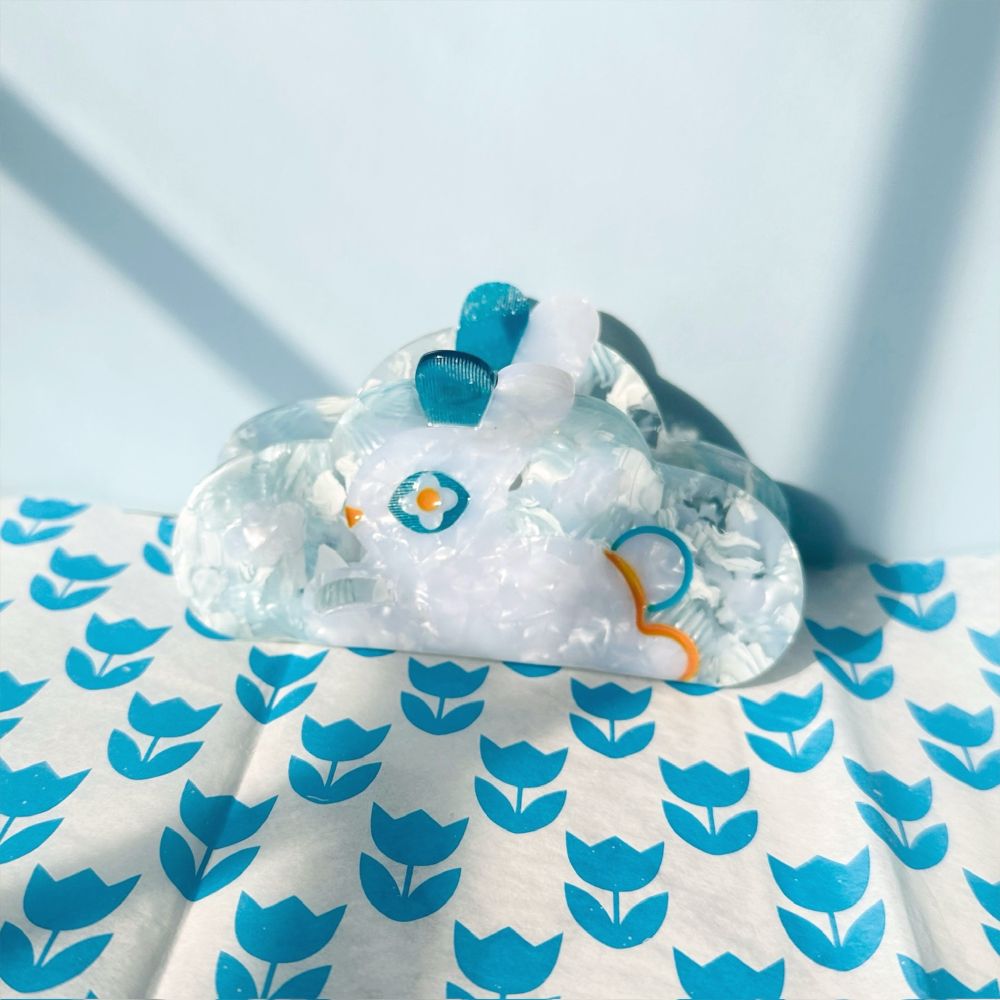 picture of my bun hairclip on a blue tulip background 