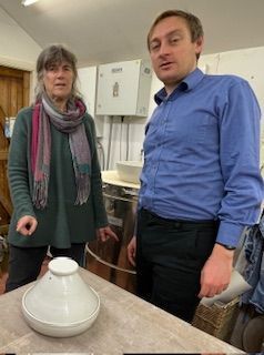 Charlotte and Olly standing by table with a tagine.