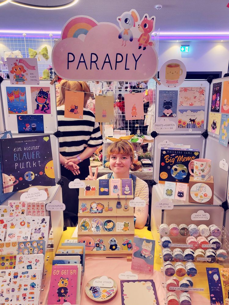 picture of me and my artist alley table :)