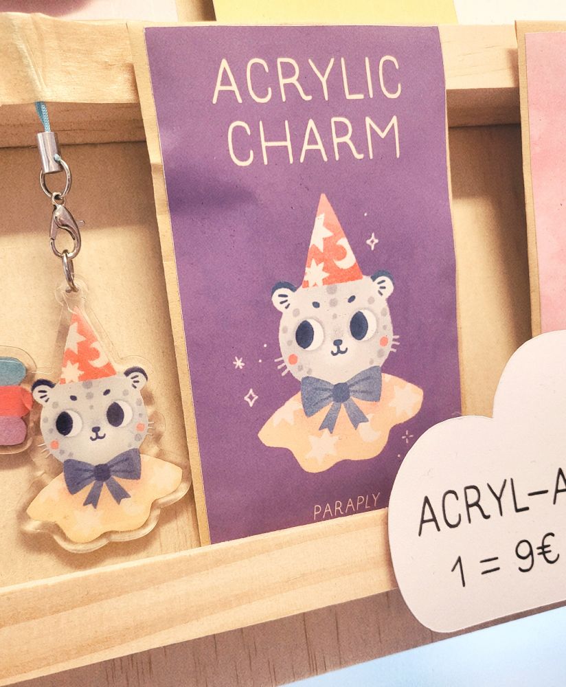 picture of my acrylic charm of Mysticus the snow leopard magician