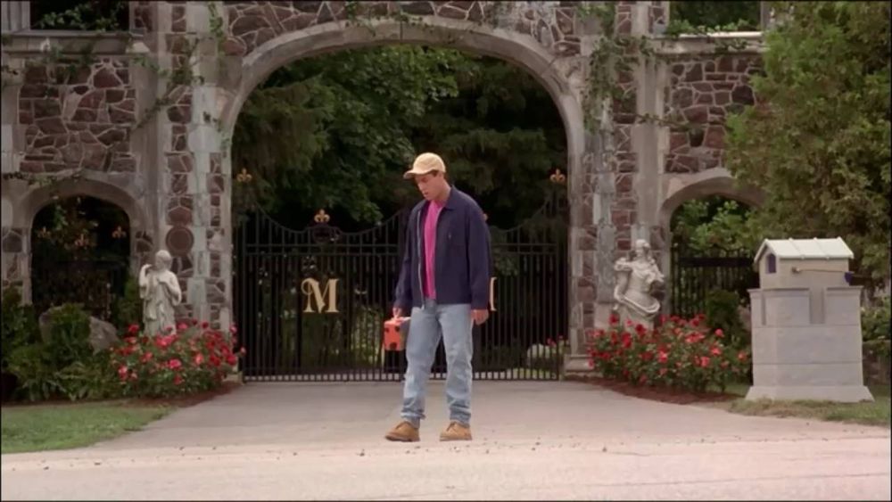 Billy Madison standing in his driveway waiting for the bus on his first day back to school 