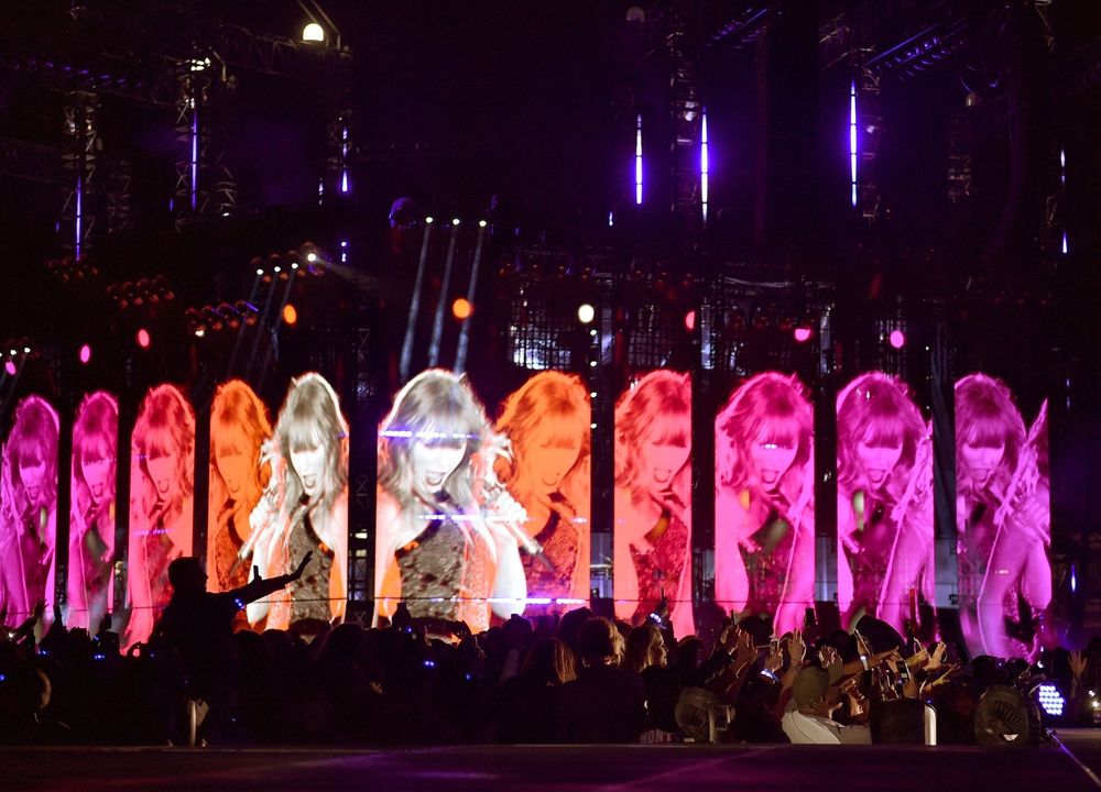 stage visuals in a pink and orange color scheme for the reputation stadium tour